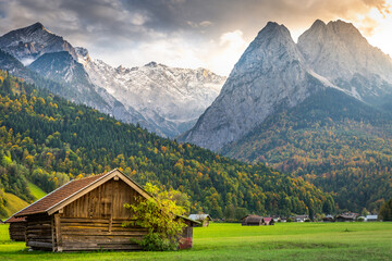 Bavarian alps autumn and wooden barn at sunset, Garmisch Partenkirchen, Germany - obrazy, fototapety, plakaty