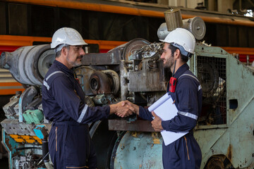 Maintenance technician checking train locomotive engine Get the machine ready for use in the train station.