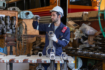 Maintenance technician checking train locomotive engine Get the machine ready for use in the train station.
