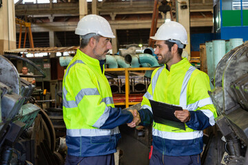 Engineer in the process of inspecting train engines Keep the machine ready for use in the train station. Engineers wear safety clothing and helmets to work safely as standard.