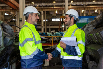 Engineer in the process of inspecting train engines Keep the machine ready for use in the train station. Engineers wear safety clothing and helmets to work safely as standard.
