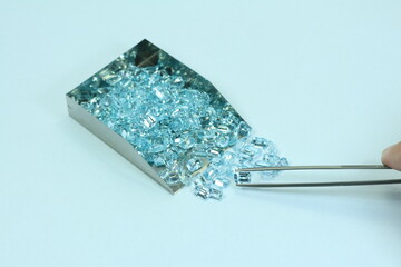 Blue aquamarine or blue topaz gemstone with light blue color on silver tray