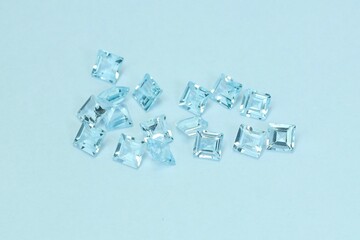 Blue aquamarine or blue topaz gemstone with light blue color on silver tray
