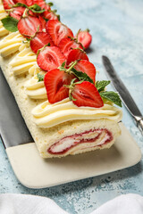 Plate with tasty strawberry roll cake on color background, closeup