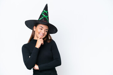 Young caucasian woman costume as witch isolated on white background looking to the side