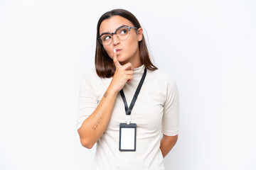 Young caucasian woman with ID card isolated on white background having doubts while looking up