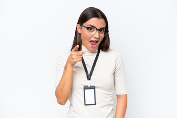 Young caucasian woman with ID card isolated on white background surprised and pointing front