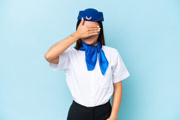 Airplane stewardess caucasian woman isolated on blue background covering eyes by hands. Do not want to see something