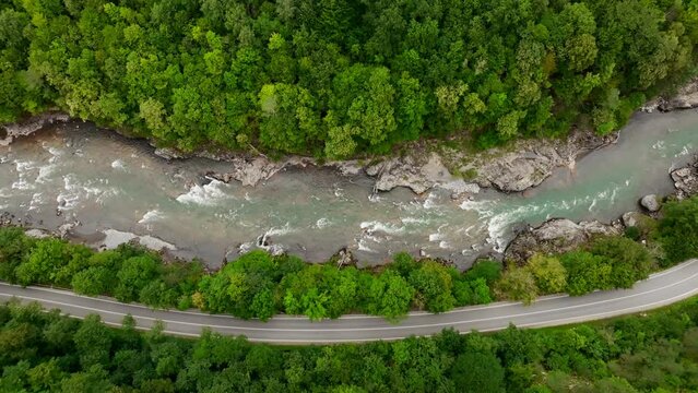 Aerial view of Mountain river and road. Flying over a mountain gorge. Slow motion video, ProRes 422