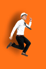 Fototapeta na wymiar Full length photo of attractive crazy young business man or engineering man jump high supporting stock market up wear striped t-shirt jeans shoes isolated bright orange color background