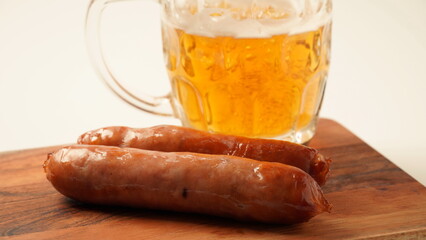Fried Bavarian Tasty sausages with a lager beer