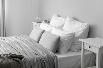 Big bed with soft pillows in modern room