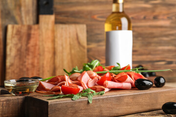 Board with sliced delicious ham on wooden table, closeup