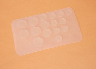 Acne patches on orange background