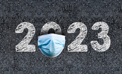 Year 2023 on asphalt road with Surgical Face Mask. happy new year 2023

