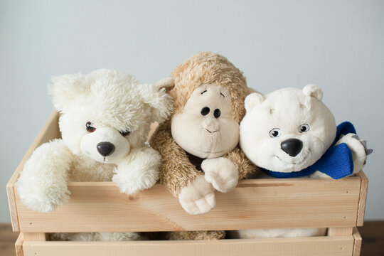 Soft children's animal toys in a wooden box
