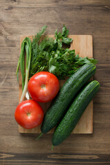Fresh herbs and vegetables on a wooden table