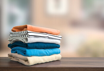 Stack of folded clothing, autumn colors stacked sweaters.Heap of clothes.Laundry,household.