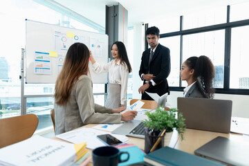 Diverse business people meeting new startup project pointing graph discussion and analysis data charts and graphs.Business finances and accounting concept