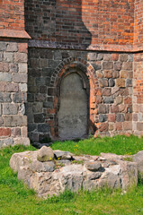 Granite foundations of an older medieval building with remnants of Gothic bricks near the church of Saint Stanislaw Kostka (former Templar chapel) at Chwarszczany, West Pomeranian voivodeship, Poland.