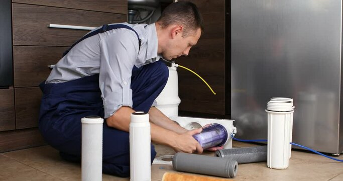 Plumber change the filter element in the water filter