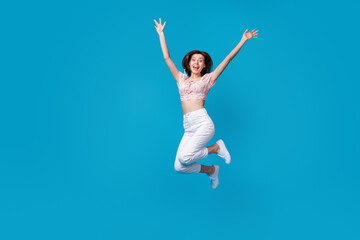Fototapeta na wymiar Photo of astonished lady dressed stylish clothes raise hand arm rejoice shopping discount empty space isolated on blue color background