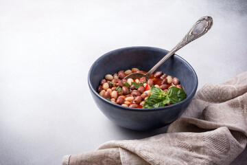 Bowl of vegetarian healthy meal with beans and tomato sauce