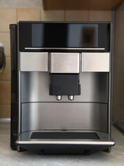 The automatic coffee machine is on the countertop.