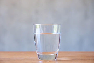A glass of drinking water on wooden table
