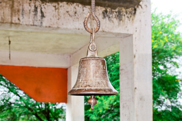 Fototapeta premium Ringing the old bell in the temple, golden metal old bell