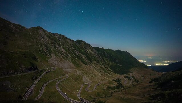 Amazing time lapse video with clear night sky at full moon over famous Transfagarasan mountain road in Romania