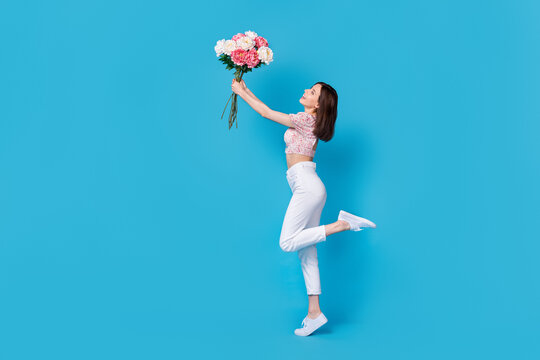 Photo of cute sweet tender girl lady trendy clothes hand hold gift surprise rejoice look empty space isolated on blue color background