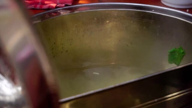 Prepare Mie Ayam, Indonesian popular food. Selective focus on boiling pot. 4K videos.