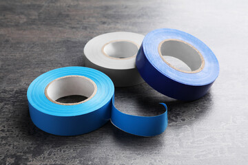 Colorful insulating tapes on dark gray background