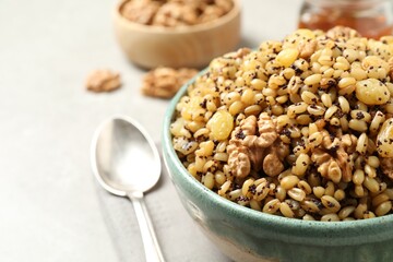 Traditional Christmas slavic dish kutia on light grey table, closeup