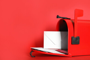 Open letter box with envelopes on red background. Space for text