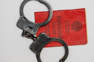 The Russian military ID card has handcuffs on it. Translation into Russian: USSR, Military ID,...