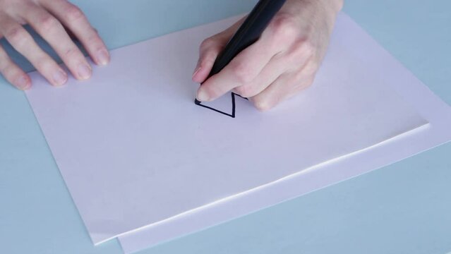 Person With Black Pentel Pen Draws A Zigzag Pattern In White Paper. High Angle
