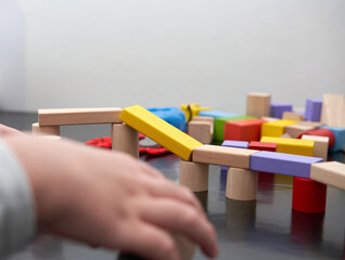 child hand play wood block toy