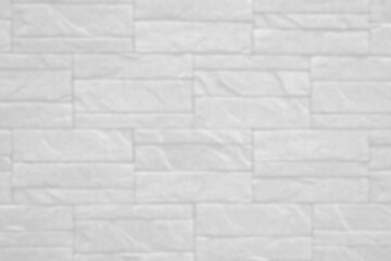 blurry white brick wall texture background for stone tile block painted in grey light color wallpaper modern interior and exterior.