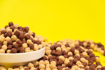 Corn sweet balls on a yellow background. Quick dry breakfasts, side view.