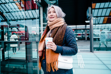 Senior woman waits for the train at the station