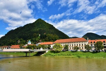 Fototapeta na wymiar View of the old historical center of the town of Lasko and Savinja river in Stajerska, Slovenia with forest covered Hum hill above