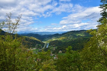 View of Savinja river valley near Lasko and forest covered hills in Stajerska, Slovenia