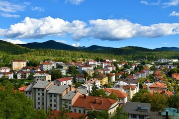 Fototapeta na wymiar View of town of Postojna in Notranjska, Slovenia with forest covered hills behind