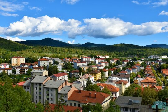 View of town of Postojna in Notranjska, Slovenia with forest covered hills behind