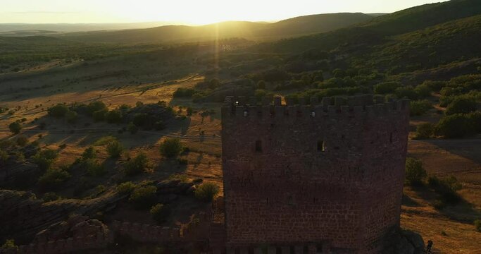 Drone Descending On Castillo de Zafra game of thrones castle During Sunset At Campillo de Due&ntilde;as In Guadalajara, Spain. Aerial Shot