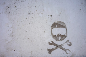 Dirty surface of a van old sticker of a motocross helmet with wrench and bone. Dirt spatter on car....
