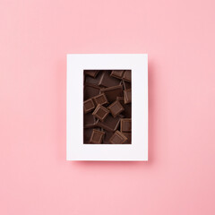 World Chocolate Day concept. Dark Chocolate on pink background.