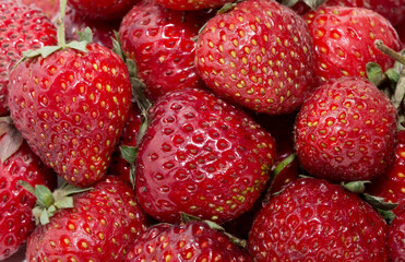 Strawberries as background top view. Strawberries close up. Juicy berries picked for dessert.
